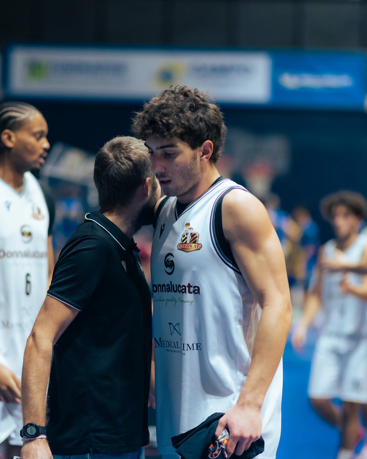 Coach guiding a player during training