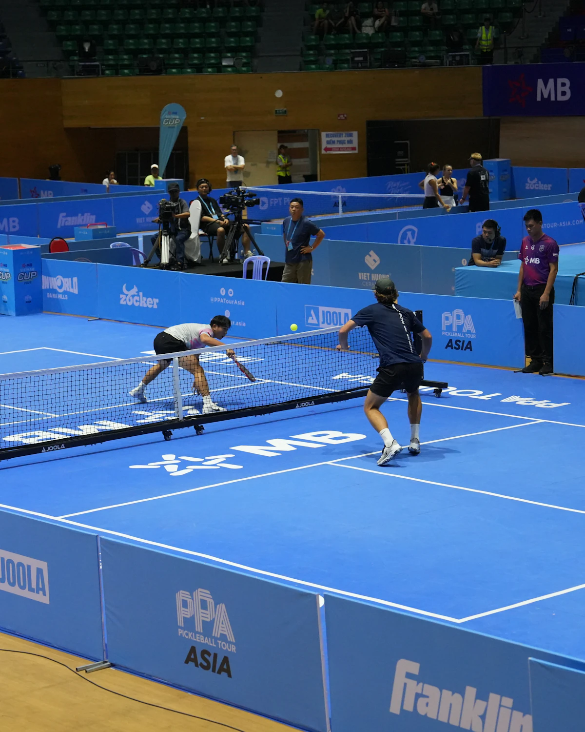 Badminton players competing in a match